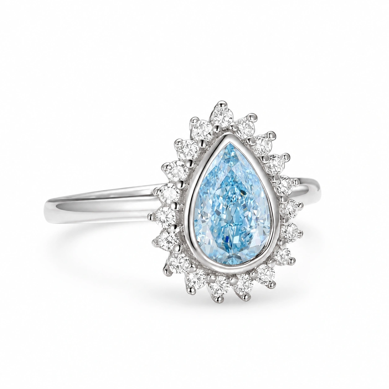 Teardrop aquamarine bezel ring in sterling silver, angled side view on white