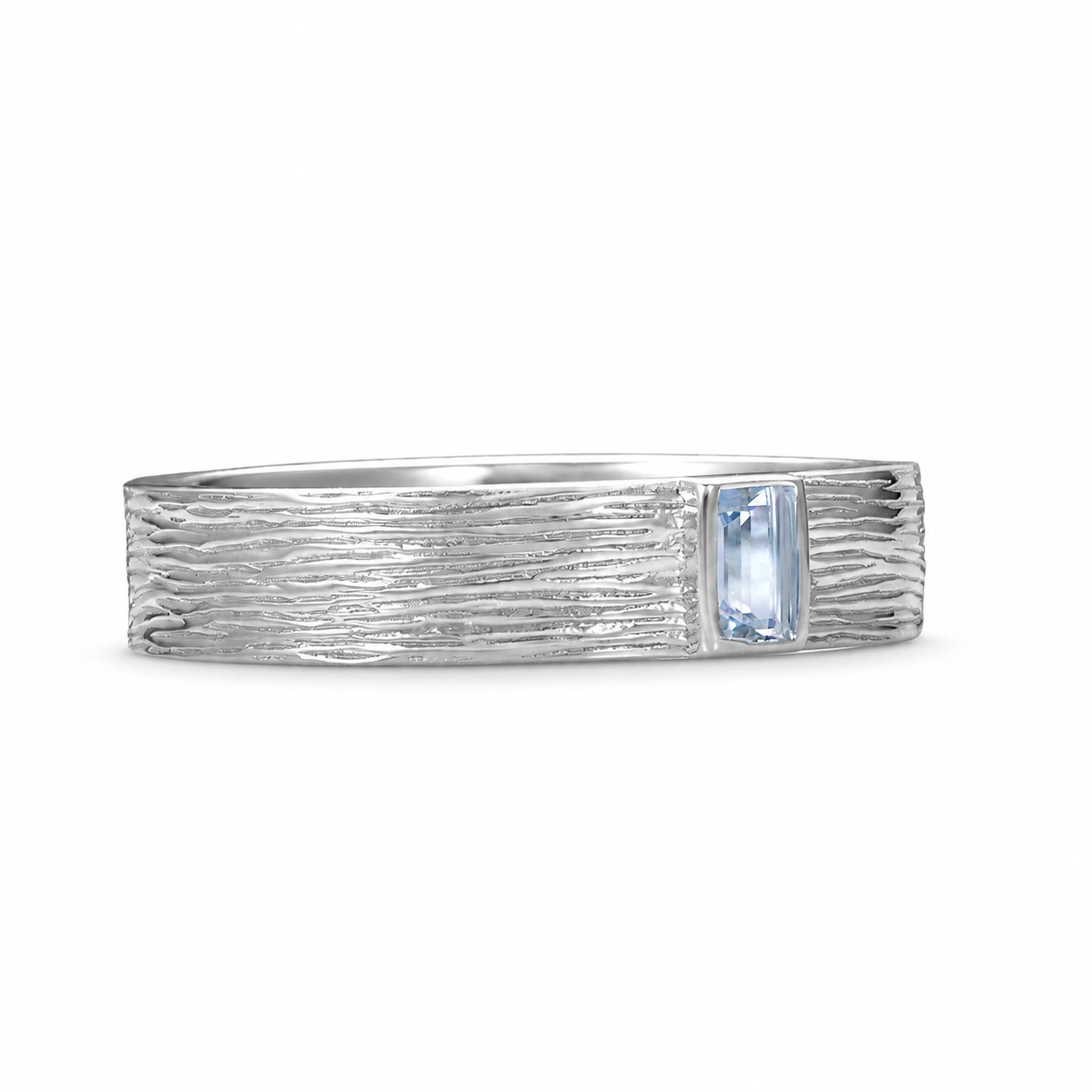 Bark-textured silver-tone ring with a rectangular pale blue stone, angled view on white.
