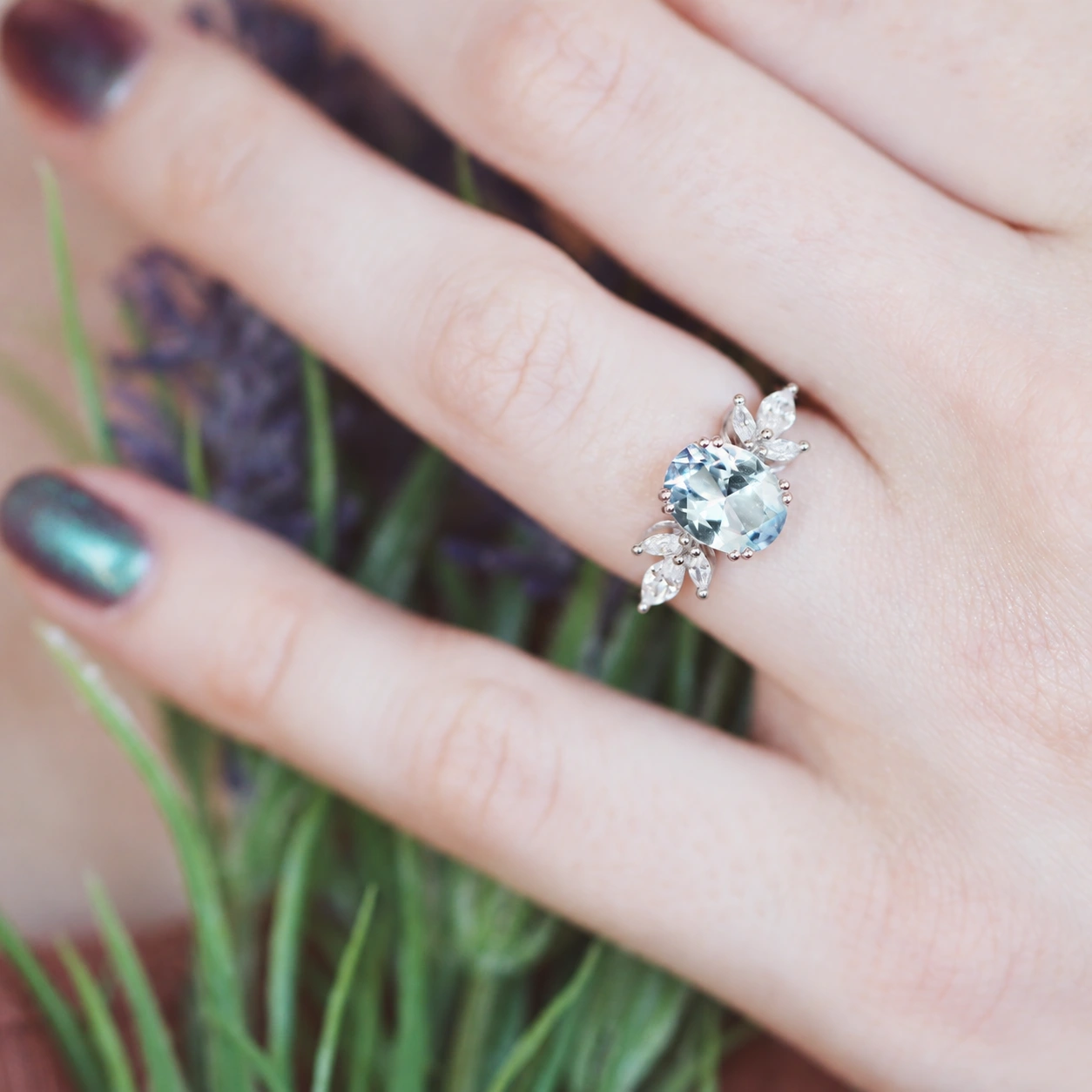 Eva oval aquamarine ring, close-up worn on hand