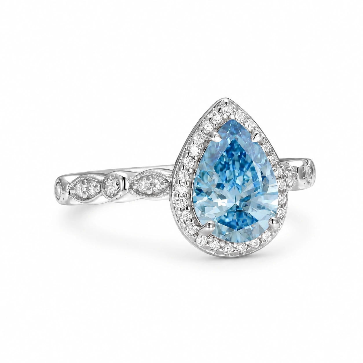 Art Deco teardrop aquamarine halo ring, angled view on white